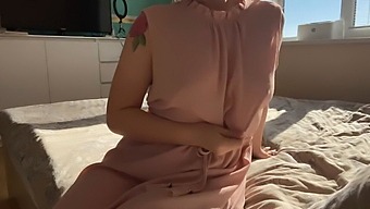 A Woman In A Feminine Pink Dress Explores Her Sensuality